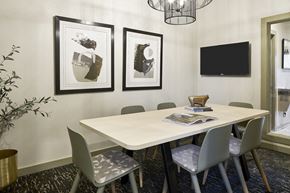 Murfreesboro apartment for rent - a conference room with a table and chairs and pictures on the wall