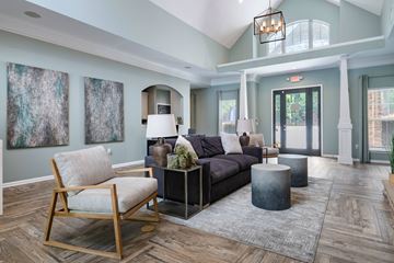 Columbia apartment for rent - A living room with a wooden chair and a grey couch.