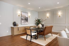 Fayetteville apartment for rent - A dining room with a table set for two and a vase of flowers on the table.