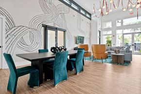 Wildwood apartment for rent - A modern dining room with a black table and blue chairs.