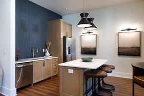 Fayetteville apartment for rent - A kitchen with a white counter top and wooden cabinets.