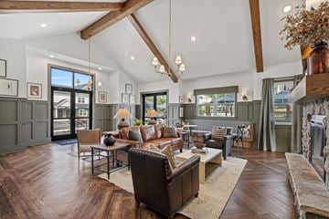 Weaverville townhouse for rent - A modern living room with a dark brown leather couch and a wooden coffee table.