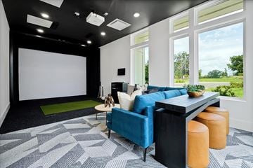 Wildwood apartment for rent - A modern living room with a blue sofa and a green rug.