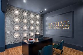 Wellford apartment for rent - A conference room with a desk and chairs with a wall of lights and a sign that says