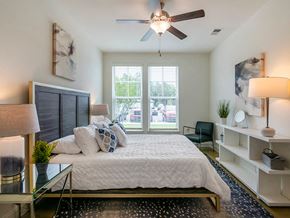 New Bern apartment for rent - a bedroom with a large bed and a ceiling fan
