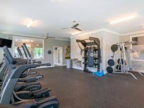 New Bern apartment for rent - the gym has plenty of cardio equipment and dumbbells
