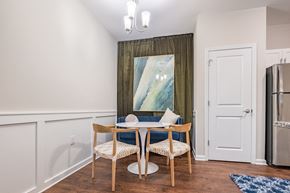 Knightdale apartment for rent - a dining room with a table and chairs and a refrigerator