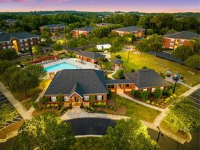 High Point apartment for rent - A large building with a pool in front of it.