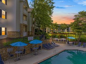 Greensboro apartment for rent - a swimming pool with umbrellas at dusk