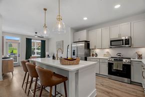 Greensboro apartment for rent - A modern kitchen with white cabinets and a large island.
