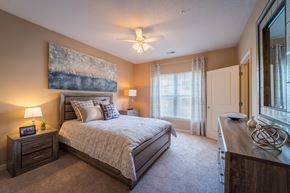 Columbia apartment for rent - A bedroom with a large bed and a ceiling fan.