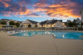 Concord apartment for rent - a swimming pool at sunset with houses in the background