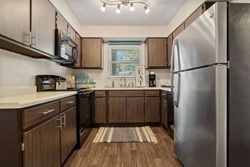 Asheville apartment for rent - a kitchen with stainless steel appliances and wooden cabinets