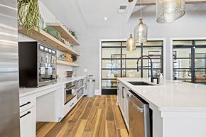 Mooresville apartment for rent - a large white kitchen with a sink and a window