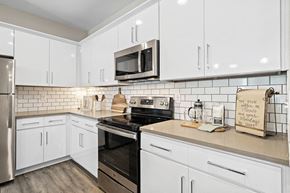 Mooresville apartment for rent - a white kitchen with a stove and a microwave