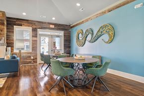 Weaverville apartment for rent - a dining room with a table and chairs and a blue wall with an abstract painting