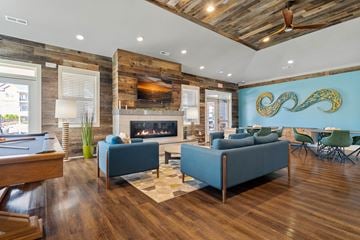 Weaverville apartment for rent - a living room with blue couches and chairs and a fireplace
