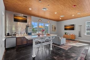 Asheville apartment for rent - A modern kitchen with a dining table and chairs.