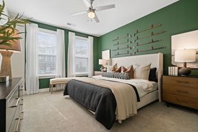 Pinehurst apartment for rent - a bedroom with green walls and a white bed