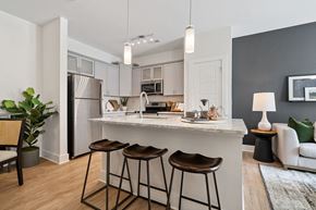 Pinehurst apartment for rent - a kitchen with a counter top and three stools