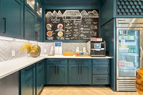 Greensboro apartment for rent - a kitchen with blue cabinets and a counter and a refrigerator
