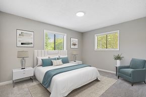 Greensboro apartment for rent - a bedroom with a bed and a chair in a 555 waverly unit