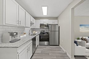 Greensboro apartment for rent - a kitchen with white cabinets and stainless steel appliances