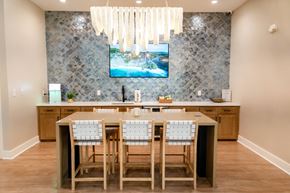 Morehead City apartment for rent - A kitchen with a table and chairs in front of a television.