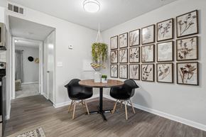 Winston Salem apartment for rent - a dining room with pictures on the wall and a table with two chairs