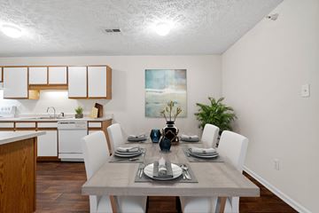 Fayetteville apartment for rent - a dining room with a table and chairs and a kitchen
