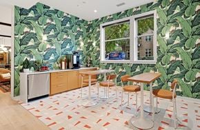 Charlotte apartment for rent - a kitchen with banana leaf wallpaper and a table with chairs