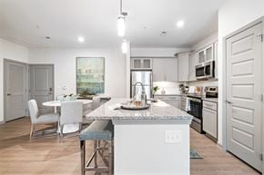 Concord apartment for rent - Designer Kitchen with Stand-Alone Island and Breakfast Bar, Granite Countertops, and Frosted Glass Cabinets