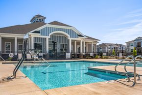 Hope Mills apartment for rent - A swimming pool in front of a house with a basketball hoop.
