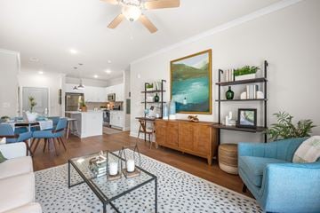 Hope Mills apartment for rent - A living room with a blue sofa and a glass coffee table.