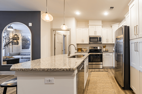 Little River townhouse for rent - a kitchen with white cabinets and a marble counter top