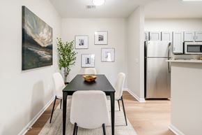 Knoxville apartment for rent - A dining room with a black table and white chairs.