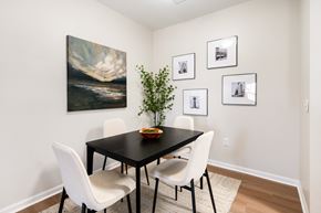 Knoxville apartment for rent - A dining room with a black table and white chairs.