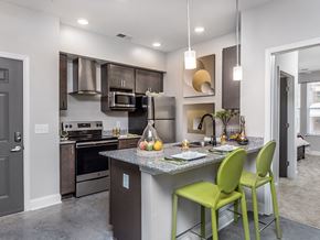 Raleigh apartment for rent - a kitchen with a bar and green stools