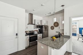 Fuquay-Varina apartment for rent - a kitchen with a counter top and a stove and a microwave
