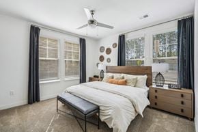 Fuquay-Varina apartment for rent - a bedroom with a bed and a ceiling fan