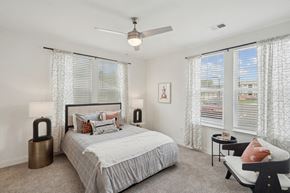 Durham apartment for rent - a bedroom with a bed and three windows