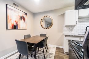 Greensboro apartment for rent - A dining room with a wooden table and chairs.