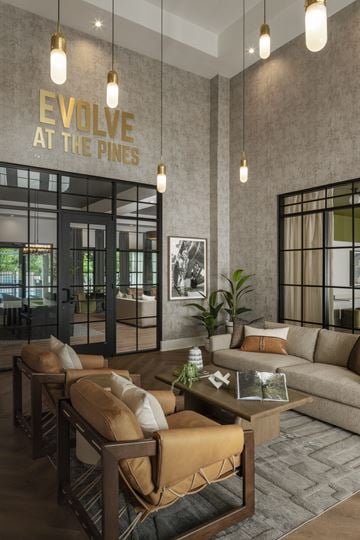 Greenville apartment for rent - A modern living room with a brown sofa and a coffee table.