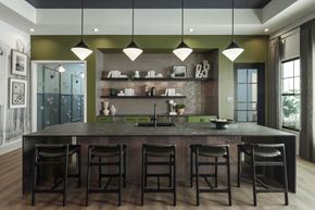 Greenville apartment for rent - A modern kitchen with a dark countertop and bar stools.