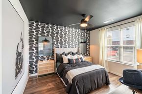 Huntersville apartment for rent - a bedroom with a bed and a patterned accent wall