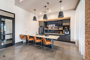 Huntersville apartment for rent - a kitchen with a long table and chairs in front of a brick wall