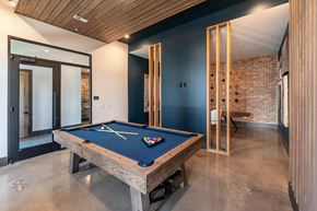 Huntersville apartment for rent - a pool table in a house with a brick wall
