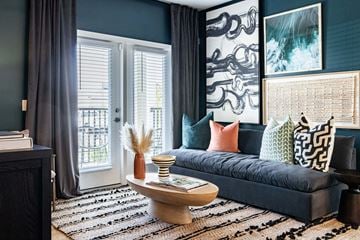 Belville apartment for rent - A living room with a dark blue sofa and a wooden coffee table.