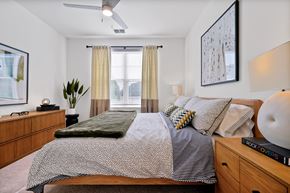 Palm Coast apartment for rent - A bedroom with a bed, nightstand, and a painting on the wall.