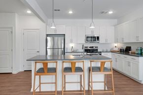 Palm Coast apartment for rent - A kitchen with white cabinets and a black countertop.